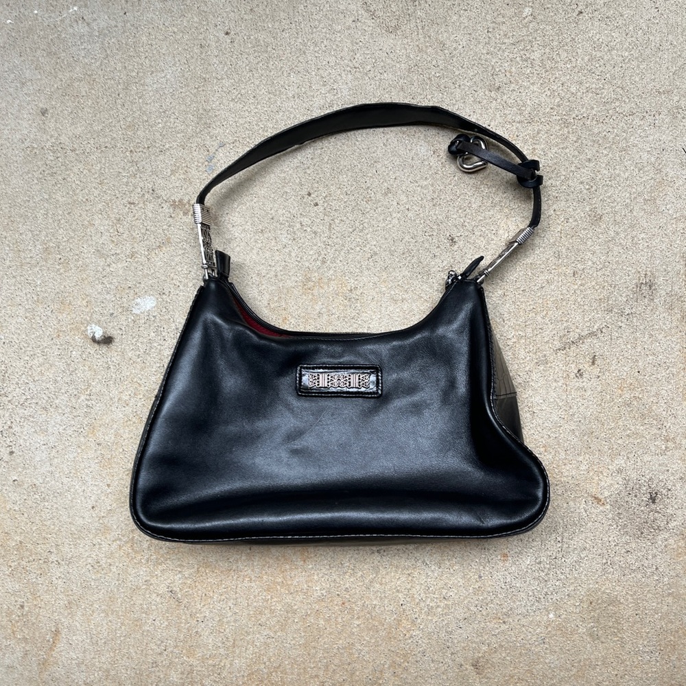 Black leather Brighton shoulder bag with red lining and silver hardware